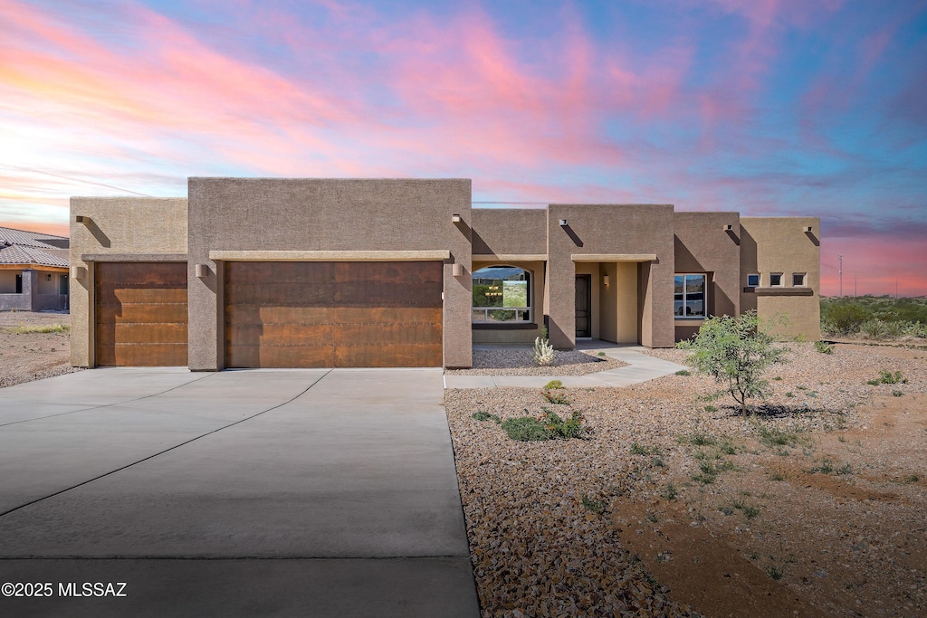 14386 E Sands Ranch Rd, Vail, AZ 85641 - adobe home with a garage, concrete driveway, and stucco siding
