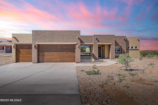 14386 E Sands Ranch Rd, Vail, AZ 85641 - adobe home with a garage, concrete driveway, and stucco siding
