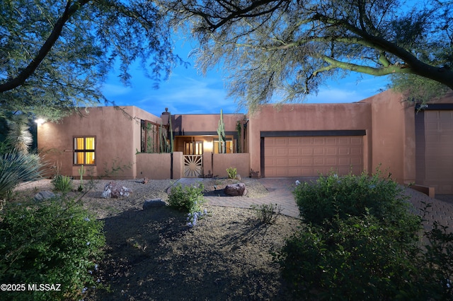 10550 N Lambert Pl, Tucson, AZ 85737 - pueblo revival-style home with a garage, stucco siding, and driveway