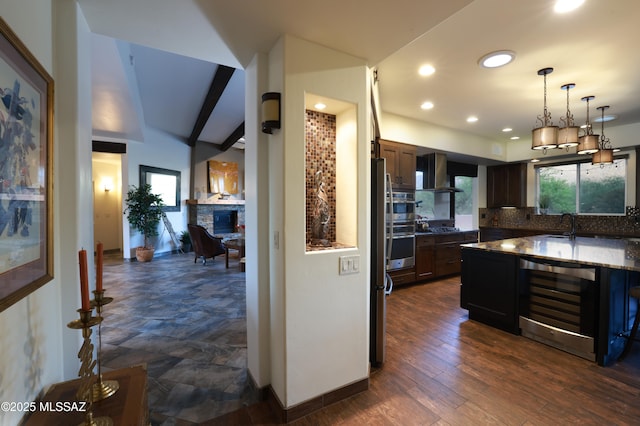 10550 N Lambert Pl, Tucson, AZ 85737 - kitchen featuring wine cooler, wall chimney range hood, backsplash, a sink, and pendant lighting