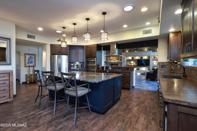 10550 N Lambert Pl, Tucson, AZ 85737 - kitchen with appliances with stainless steel finishes, a sink, a large island, backsplash, and dark wood-style flooring