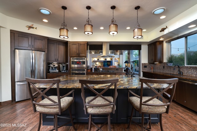 10550 N Lambert Pl, Tucson, AZ 85737 - kitchen with stainless steel appliances, island exhaust hood, tasteful backsplash, dark brown cabinetry, and recessed lighting