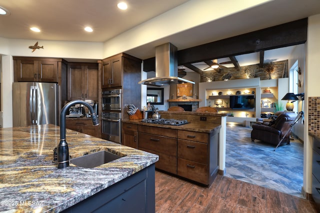 10550 N Lambert Pl, Tucson, AZ 85737 - kitchen with stainless steel appliances, island range hood, dark stone counters, open floor plan, and a sink