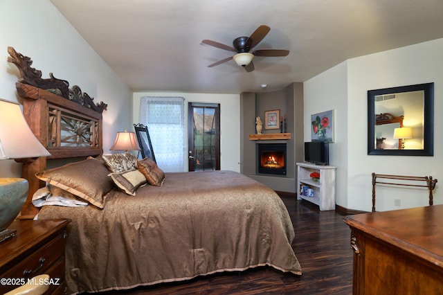 10550 N Lambert Pl, Tucson, AZ 85737 - bedroom with dark wood-style floors, a lit fireplace, baseboards, ceiling fan, and access to outside