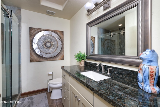10550 N Lambert Pl, Tucson, AZ 85737 - bathroom featuring vanity, a shower stall, toilet, wood finished floors, and baseboards