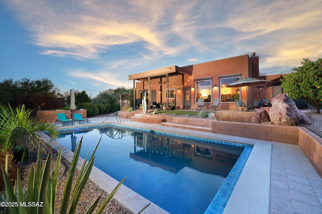 10550 N Lambert Pl, Tucson, AZ 85737 - pool at dusk with an outdoor pool and a patio area