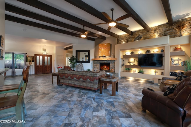 10550 N Lambert Pl, Tucson, AZ 85737 - living area featuring a stone fireplace, ceiling fan, beam ceiling, and stone finish flooring