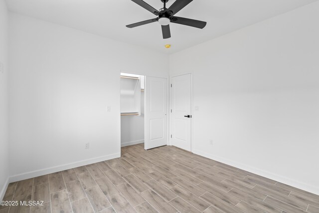 1917 Circulo Mexicali, Rio Rico, AZ 85648 - unfurnished bedroom with wood finished floors, baseboards, a ceiling fan, and a closet