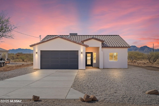1917 Circulo Mexicali, Rio Rico, AZ 85648 - mediterranean / spanish-style house with driveway, a tile roof, an attached garage, stucco siding, and a mountain view