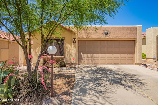 231 E Highcourte Ln, Tucson, AZ 85737 - pueblo-style home featuring driveway, stucco siding, and a garage