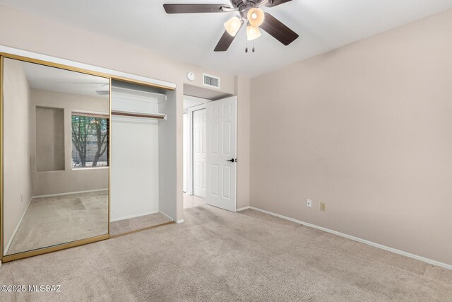 231 E Highcourte Ln, Tucson, AZ 85737 - unfurnished bedroom featuring carpet, a closet, baseboards, and ceiling fan