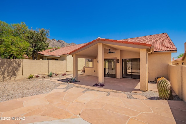 231 E Highcourte Ln, Tucson, AZ 85737 - back of property with ceiling fan, a tile roof, stucco siding, and a fenced backyard