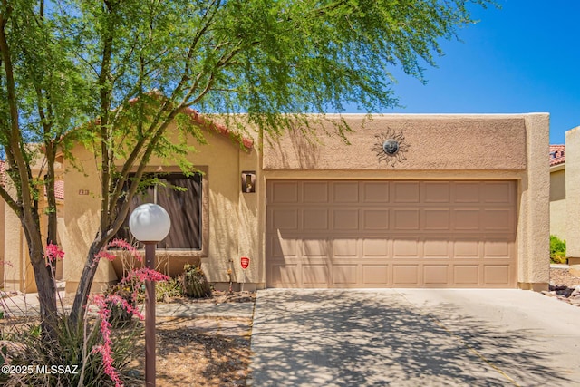 231 E Highcourte Ln, Tucson, AZ 85737 - pueblo-style house with stucco siding, driveway, and an attached garage