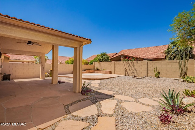 231 E Highcourte Ln, Tucson, AZ 85737 - fenced backyard with ceiling fan and a patio