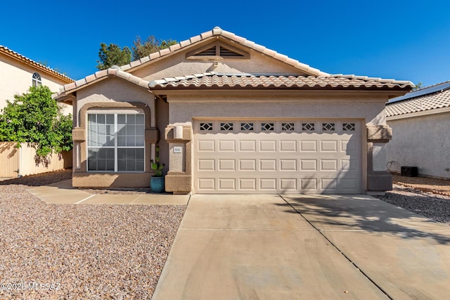 9102 N Safflower Ln, Tucson, AZ 85743 - view of front of house with a garage, driveway, stucco siding, and a tiled roof