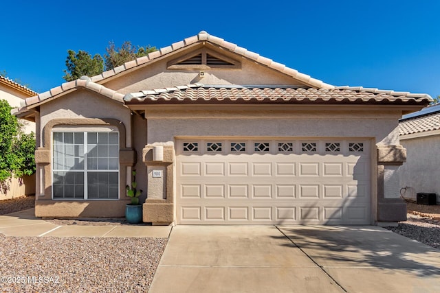 9102 N Safflower Ln, Tucson, AZ 85743 - view of front facade with a garage, concrete driveway, a tile roof, and stucco siding