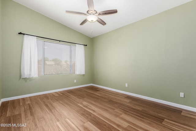 9102 N Safflower Ln, Tucson, AZ 85743 - unfurnished room with vaulted ceiling, a ceiling fan, wood finished floors, and baseboards