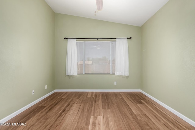 9102 N Safflower Ln, Tucson, AZ 85743 - spare room with wood finished floors, lofted ceiling, and baseboards