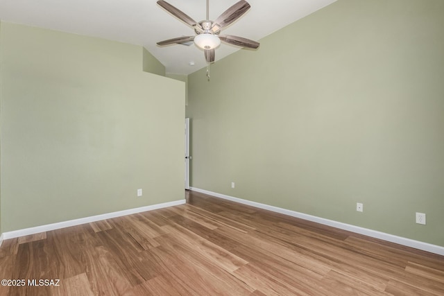 9102 N Safflower Ln, Tucson, AZ 85743 - spare room with a ceiling fan, light wood finished floors, lofted ceiling, and baseboards