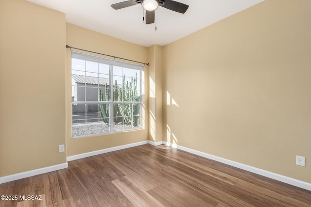 9102 N Safflower Ln, Tucson, AZ 85743 - empty room featuring wood finished floors, ceiling fan, and baseboards