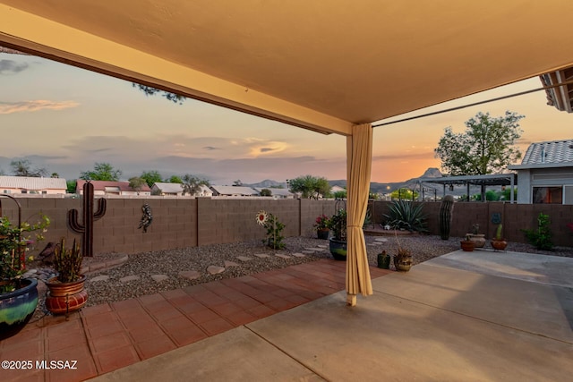9102 N Safflower Ln, Tucson, AZ 85743 - patio terrace at dusk with a patio area and a fenced backyard
