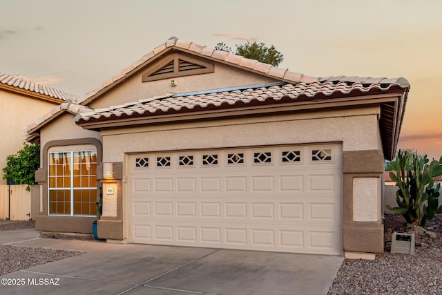 9102 N Safflower Ln, Tucson, AZ 85743 - view of front of home featuring driveway, a tiled roof, stucco siding, and an attached garage