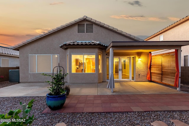 9102 N Safflower Ln, Tucson, AZ 85743 - rear view of house with french doors, stucco siding, a patio area, and a tiled roof