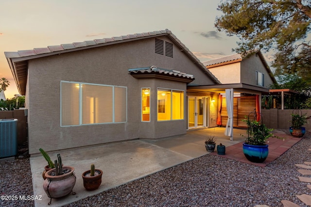 9102 N Safflower Ln, Tucson, AZ 85743 - back of property featuring french doors, cooling unit, stucco siding, a patio, and a tiled roof