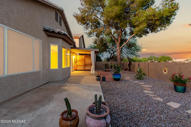 9102 N Safflower Ln, Tucson, AZ 85743 - yard at dusk with a fenced backyard and a patio