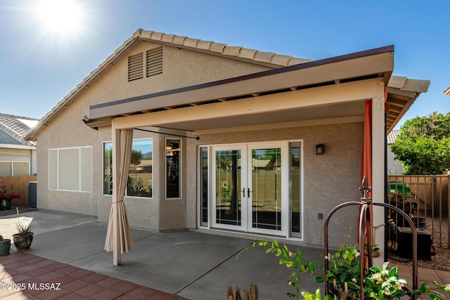 9102 N Safflower Ln, Tucson, AZ 85743 - back of property with french doors, stucco siding, and a patio
