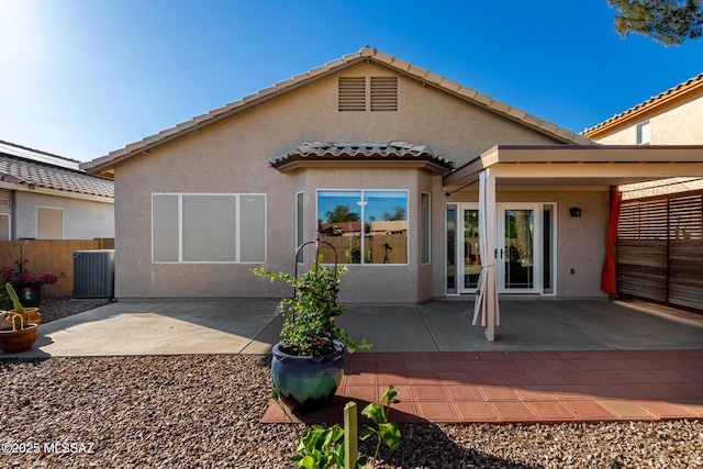 9102 N Safflower Ln, Tucson, AZ 85743 - back of property featuring stucco siding, a tiled roof, and a patio area