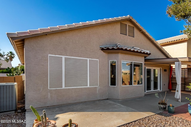 9102 N Safflower Ln, Tucson, AZ 85743 - back of property featuring cooling unit, a patio area, french doors, a tiled roof, and stucco siding