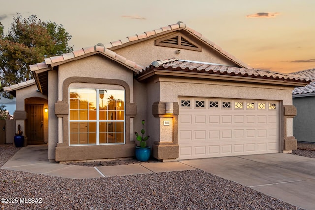 9102 N Safflower Ln, Tucson, AZ 85743 - view of front facade with stucco siding, a tile roof, concrete driveway, and an attached garage