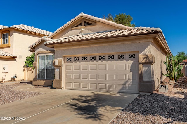 9102 N Safflower Ln, Tucson, AZ 85743 - view of front of home with an attached garage, concrete driveway, and a tile roof