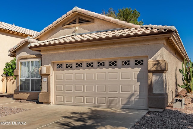 9102 N Safflower Ln, Tucson, AZ 85743 - view of front of home with a garage, a tiled roof, concrete driveway, and stucco siding