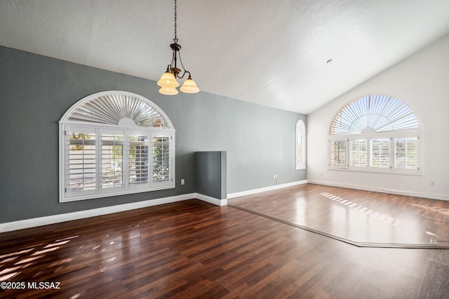 11562 N Scioto Ave, Tucson, AZ 85737 - unfurnished living room featuring vaulted ceiling, wood finished floors, a chandelier, and baseboards