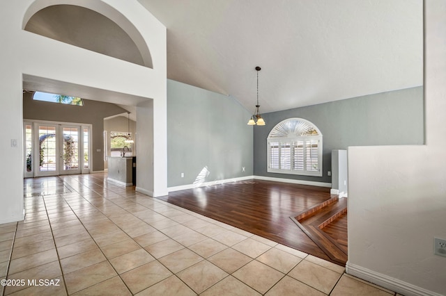 11562 N Scioto Ave, Tucson, AZ 85737 - empty room with high vaulted ceiling, healthy amount of natural light, baseboards, and tile patterned floors