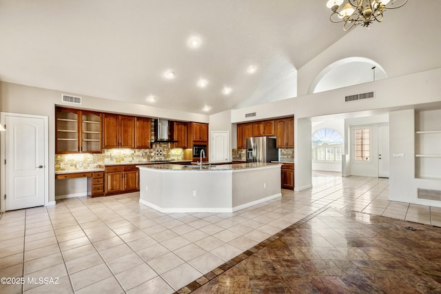 11562 N Scioto Ave, Tucson, AZ 85737 - kitchen featuring stainless steel refrigerator with ice dispenser, wall chimney exhaust hood, a chandelier, light tile patterned floors, and backsplash