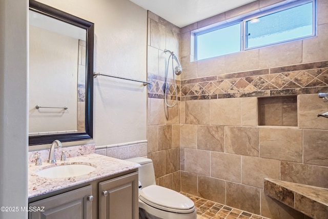 11562 N Scioto Ave, Tucson, AZ 85737 - full bath with toilet, tiled shower, vanity, and tile walls