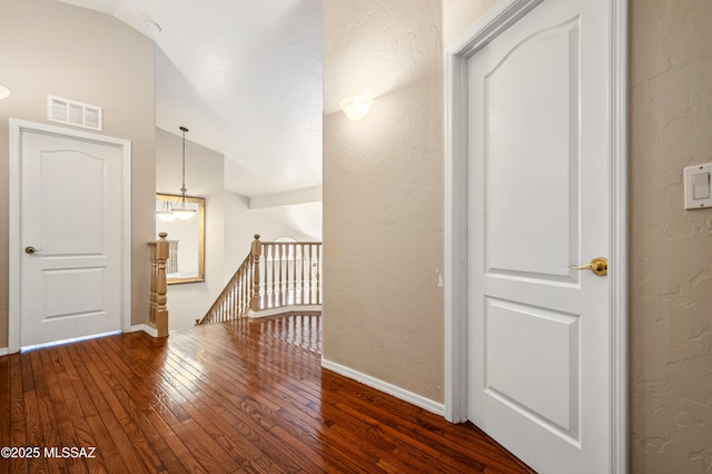 11562 N Scioto Ave, Tucson, AZ 85737 - corridor featuring an upstairs landing, vaulted ceiling, hardwood / wood-style flooring, baseboards, and a textured wall