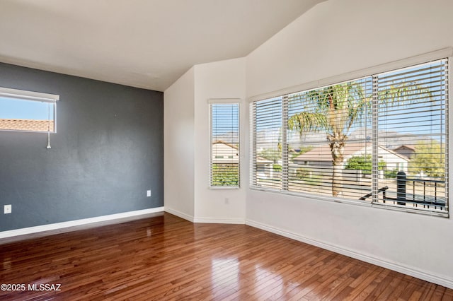 11562 N Scioto Ave, Tucson, AZ 85737 - empty room featuring lofted ceiling, wood finished floors, and baseboards