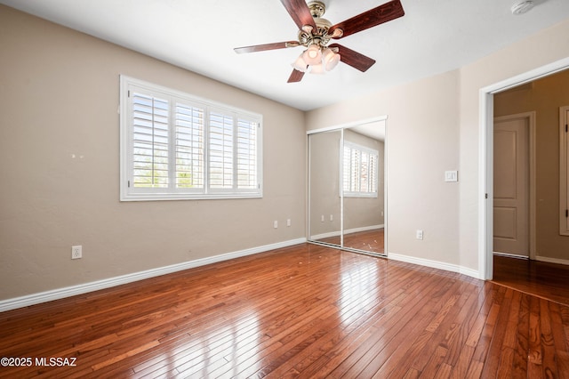11562 N Scioto Ave, Tucson, AZ 85737 - unfurnished bedroom featuring wood-type flooring, baseboards, a closet, and a ceiling fan