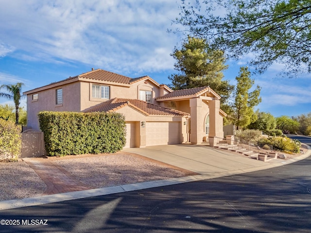 11562 N Scioto Ave, Tucson, AZ 85737 - mediterranean / spanish-style house with an attached garage, stucco siding, a tiled roof, and concrete driveway