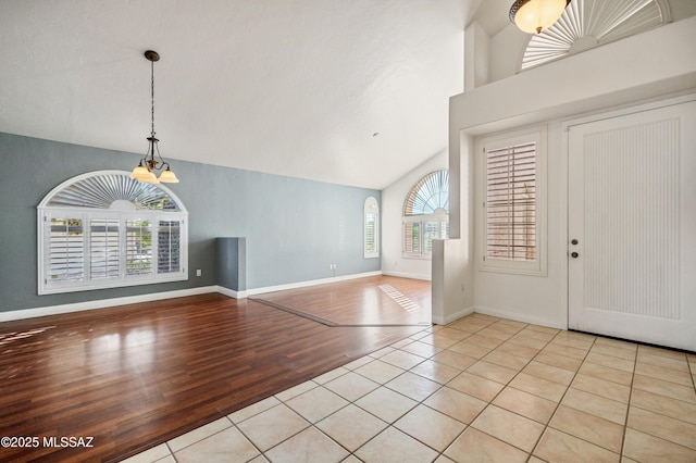 11562 N Scioto Ave, Tucson, AZ 85737 - foyer featuring light tile patterned floors, a chandelier, baseboards, and lofted ceiling