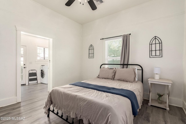 118 N Hoff Ave, Tucson, AZ 85705 - bedroom featuring washer / clothes dryer, wood finished floors, baseboards, and ceiling fan
