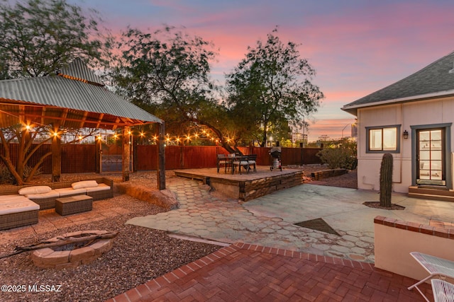 118 N Hoff Ave, Tucson, AZ 85705 - fenced backyard with an outdoor fire pit, a patio area, and a gazebo