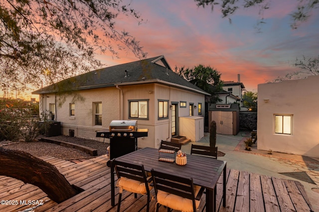 118 N Hoff Ave, Tucson, AZ 85705 - wooden deck featuring a grill, outdoor dining space, and a patio area