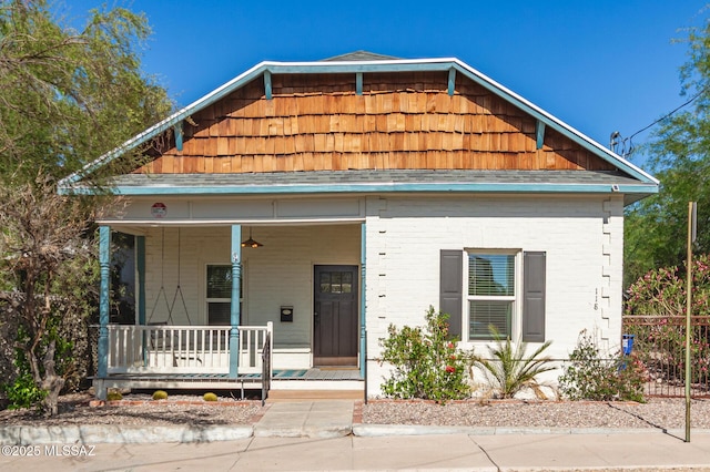 118 N Hoff Ave, Tucson, AZ 85705 - view of front facade featuring covered porch and brick siding