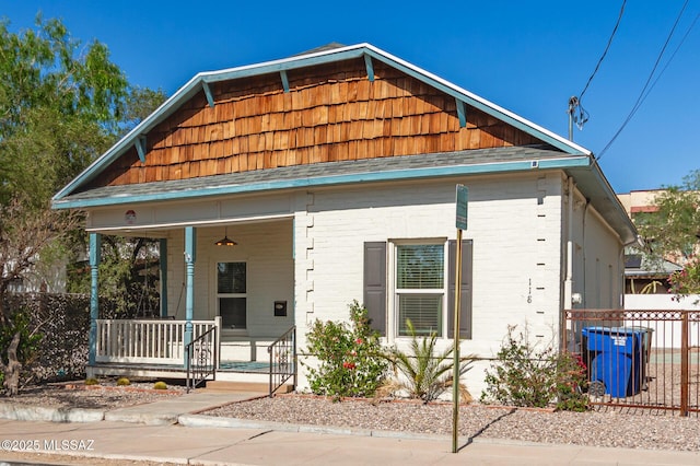 118 N Hoff Ave, Tucson, AZ 85705 - shotgun-style home featuring a porch and brick siding
