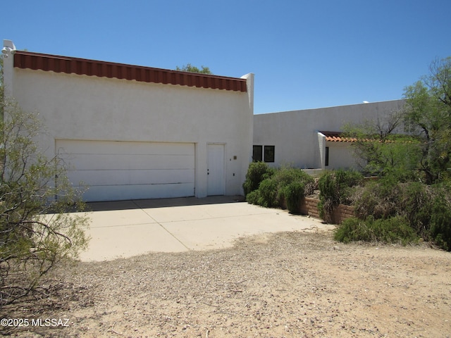 11985 N Cayce Ln, Casa Grande, AZ 85194 - view of front of home with stucco siding, an attached garage, and concrete driveway
